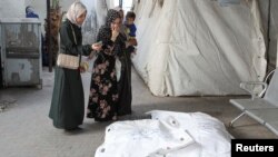 Mourners react next to the bodies of Palestinians killed in an Israeli strike, at Abu Yousef al-Najjar hospital in Rafah, May 5, 2024. 