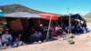FILE - A group of people wait to be processed after crossing the border between Mexico and the United States as they seek asylum, April 17, 2024, near Jacumba, Calif.