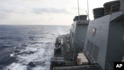 In this photo provided by the U.S. Navy, the Arleigh Burke-class guided-missile destroyer USS Milius (DDG 69) conducts routine underway operations in South China Sea, March 24, 2023.