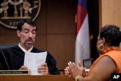 County Clerk Che Alexander, right speaks with Fulton County Superior Court Judge Robert McBurney, in Atlanta, Aug. 14, 2023.