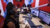 FILE - A radio presenter speaks about a second wave of COVID-19 in Nigeria, from the studio of HOT FM station in Lagos, March 9, 2020. 