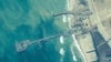 FILE - This image provided by U.S. Central Command shows U.S. and Israeli military personnel placing a floating pier on the coast of the Gaza Strip on May 16, 2024. U.S. officials announced June 28 that the pier had been detached and was being moved because of rough seas.