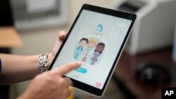 An employee of Hazel Health displays the opening page of the company's app, Tuesday, Oct. 10, 2023 (AP Photo/Rebecca Blackwell)
