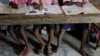 FILE - Students read books at a primary school on Ghoramara Island, India, Nov. 16, 2018. A teacher at a private elementary school in the state of Uttar Pradesh has come under fire for allegedly asking students to slap a Muslim classmate.