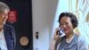 Chinese Australian journalist Cheng Lei, right, talks on the phone as Australia's Minister for Foreign Affairs, Penny Wong, watches at Tullamarine Airport in Melbourne, Oct. 11, 2023. 