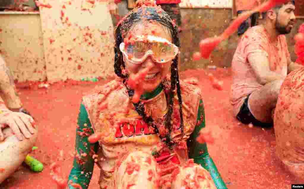 A participant covered in tomato pulp looks on during the annual food fight festival 'La Tomatina' in Bunol, near Valencia, Spain, Aug. 28, 2024.