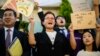 Climate activists cheer outside South Korea's Constitutional Court in Seoul on August 29, 2024, after the court ruled that much of the country's climate goals were unconstitutional.