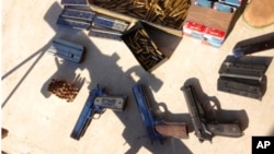 FILE - In this undated photo provided by the United States Attorney's Office for the Eastern District of New York, a cache of weapons and ammunition seized by authorities from the Sinaloa cartel is shown. 