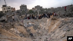 Palestinians look for survivors following an Israeli airstrike in Khan Younis, southern Gaza Strip, Nov. 12, 2023.