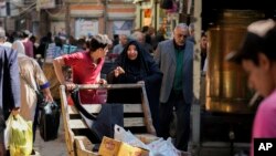 FILE - People shop at a market in Baghdad, Iraq, March. 7, 2024. In late November, the country will conduct its first census in almost three decades.