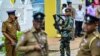 Police and navy personnel stand guard as presidential candidates file nomination papers for the upcoming presidential elections outside the Election Commission office in Colombo, Sri Lanka, on Aug. 15, 2024.
