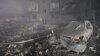 A rescuer works at a site of a residential building heavily damaged by a Russian missile strike in Zaporizhzhia, Ukraine, Oct. 10, 2022.