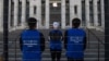 FILE - Activists set up a mock Uyghur forced labor camp outside the Apple flagship store in Washington, D.C., March 4, 2022. Demonstrators called on tech giant Apple to stop using Uyghur forced labor.