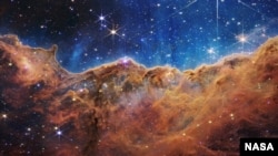 This image of a nearby, young, star-forming region called NGC 3324 in the Carina Nebula was released by NASA July 12, 2022. Captured in infrared light by the James Webb Space Telescope, this image reveals for the first time previously invisible areas of s