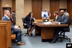 FILE - Fulton County prosecutor Fani Willis, center, and her team, during proceedings to seat a special purpose grand jury in Fulton County, Georgia, on May 2, 2022, to look into the actions of former President Donald Trump and his supporters.