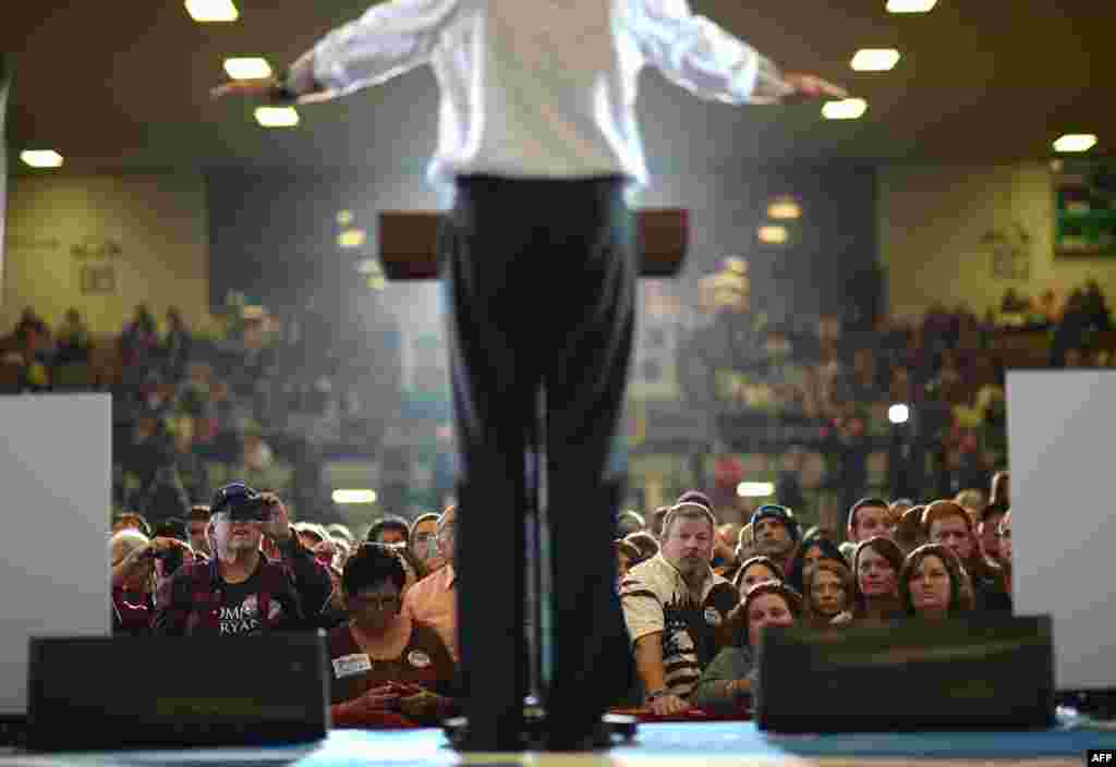 Supporters listen to Republican Presidential candidate Mitt Romney during a rally at the Veterans Memorial Coliseum in Marion, Ohio, October 28, 2012.