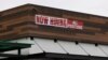 FILE - A restaurant advertising jobs looks to attract workers in Oceanside, California, May 10, 2021. 