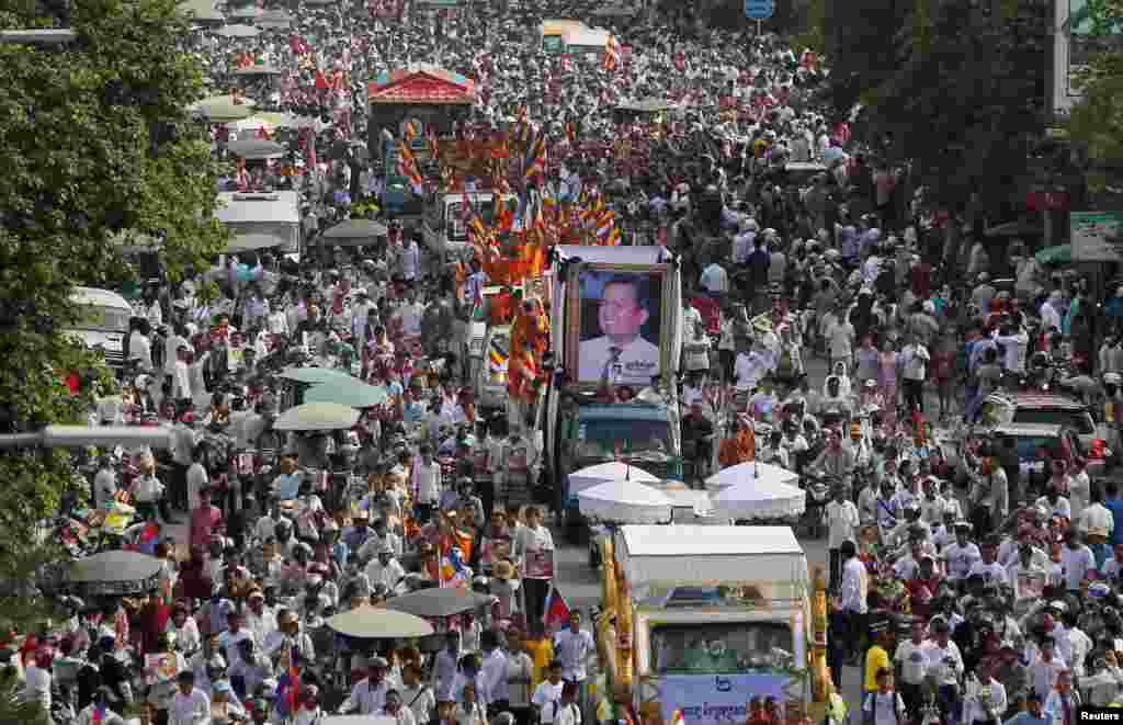 Tens of thousands of people attend a funeral procession to carry the body of Kem Ley, an anti-government figure and the head of a grassroots advocacy group "Khmer for Khmer", to his hometown, in Phnom Penh, Cambodia. Kem Ley was shot dead on July 10.