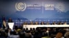 FILE - Sameh Shoukry, president of the COP27 climate summit, left, speaks during an opening session at the COP27 U.N. Climate Summit, Nov. 6, 2022, in Sharm el-Sheikh, Egypt.