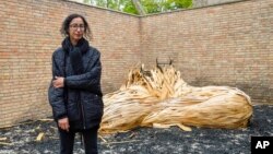 Artist Latifa Echakhch poses for photos in front of an installation during the opening of the Swiss Pavillion at the 59th Biennale of Arts exhibition, in Venice, April 21, 2022.