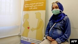 FILE - A Lebanese mother-to-be waits for her turn at a clinic providing free consultations in Beirut, Lebanon, Sept. 18, 2020.