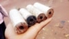 A refugee holding remains of teargas police used to stop the violence at the camp. (Courtesy picture by refugees who witnessed the violence)