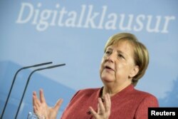 German Chancellor Angela Merkel attends a press conference after the federal cabinet meeting in Potsdam, Germany, Nov. 15, 2018.