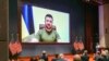 Members of Congress give Ukraine President Volodymyr Zelensky a standing ovation before he speaks in a virtual address to Congress in the U.S. Capitol Visitors Center Congressional Auditorium in Washington, on Wednesday, March 16, 2022.