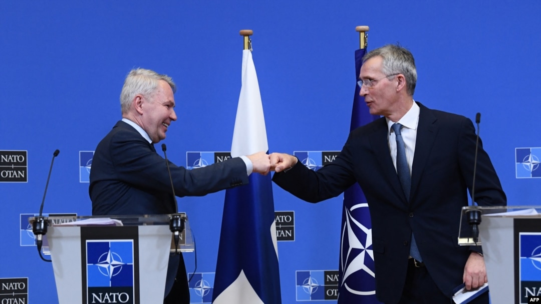 NATO Secretary General Jens Stoltenberg (R) and Finland Ministers for Foreign Affairs Pekka Haavisto (L) bump fists after holding a joint press conference after their meeting at the Nato headquarters in Brussels on January 24, 2022. (Photo by JOHN THYS / AFP) 