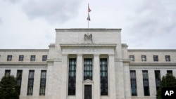 FILE - This May 4, 2021, file photo shows the Federal Reserve building in Washington.