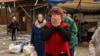 Hours after fleeing her village, a woman sobs, saying, "I thought I was dead," on the outskirts of Kharkiv, Ukraine, April 28, 2022. (Yan Boechat/VOA)

