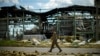 A Ukrainian serviceman walks past a gypsum manufacturing plant destroyed in a Russian bombing in Bakhmut in eastern Ukraine, May 28, 2022.
