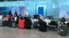 FILE - Masked travelers are seen in a waiting area at Guangzhou Baiyun Airport in China's southern Guangdong province, Dec. 25 2022. 