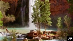 FILE - Hikers enjoy the pools below Havasu Falls, one of three main waterfalls in Havasupai Canyon in Supai, Arizona, a pocket of the Grand Canyon, on April 8, 2006.