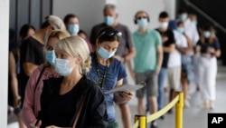 People wait in a line at a COVID-19 testing station on the northern beaches in Sydney, Australia, Dec. 21, 2020. 