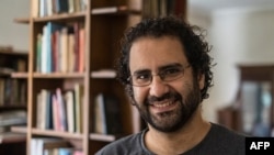 FILE - This photo taken on May 17, 2019, shows Egyptian activist and blogger Alaa Abdel Fattah at his Cairo home. His family said on Nov. 6, 2022, that he has stopped drinking water, escalating his hunger strike as world leaders arrive in Egypt for the COP27 climate summit. 