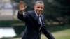  President Barack Obama waves following his arrival on Marine One helicopter from the House Democratic Issues Conference in Lansdowne, Virginia, as he walks across the South Lawn of the White House in Washington, February 7, 2013.