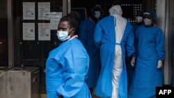 FILE - Medical staff members in protective gear are seen at Mubende Regional Referral Hospital, in Mubende, Uganda, Sept. 24, 2022.