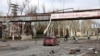 Local residents walk past a destroyed part of the Illich Iron & Steel Works Metallurgical Plant, the second largest metallurgical enterprise in Ukraine, in Mariupol, April 16, 2022.