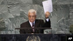 Palestinian President Mahmoud Abbas holds up a copy of the letter that he had just delivered to UN Secretary-General Ban Ki-moon requesting full UN representation for a Palestinian state, during his address before the 66th United Nations General Assembly
