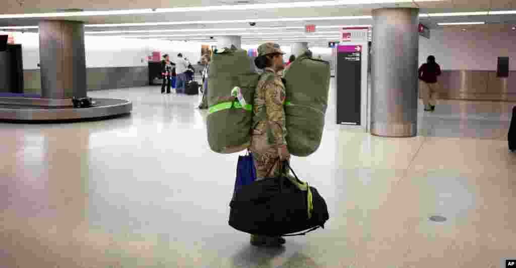 U.S. Army Sgt. Angelica Ciriaco makes her way home at the Miami International Airport after serving 10 months in Afghanistan, Nov. 26, 2013.