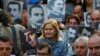 FILE - Human rights activists hold portraits of victims during a demonstration to commemorate the 1915 mass killing of Armenians in the Ottoman Empire, in central Istanbul, Turkey, Apr. 24, 2018. 