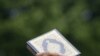 A Muslim protester holds up a copy of Quran during a protest against the burning of Qurans in Afghanistan by U.S. troops, outside the U.S. Embassy in Kuala Lumpur, Malaysia, Feb. 24, 2012.