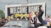 FILE - In this June 22, 1992 file photo, former hostage Terry Anderson waves to the crowd as he rides in a parade in his honor in Lorain, Ohio. 