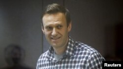 FILE - Russian opposition politician Alexey Navalny attends a court hearing in Moscow, Russia, Feb. 20, 2021. 