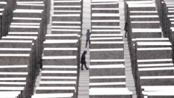 FILE - People visit the the Memorial for the Murdered Jews of Europe, the so-called Holocaust Memorial, during a snowfall in Berlin, Germany, Dec. 9, 2021.