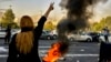 FILE - In this photo taken by an individual not employed by the Associated Press and obtained by the AP outside Iran, Iranians protest the death of Mahsa Amini, 22, after she was detained by the country's morality police, in Tehran, Oct. 1, 2022.