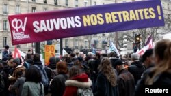 Para pengunjuk rasa memegang spanduk bertuliskan "Selamatkan pensiun kami" selama demonstrasi menentang rencana reformasi pensiun pemerintah Prancis di Paris, Selasa 31 Januari 2023.