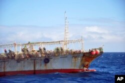 FILE - The Chinese squid fishing vessel Fu Yuan Yu 7880 sails on the Pacific Ocean on July 18, 2021. The Pingtan-affiliated vessel was arrested by South Africa in 2016 after it tried to flee a naval patrol that suspected it of illegal squid fishing.