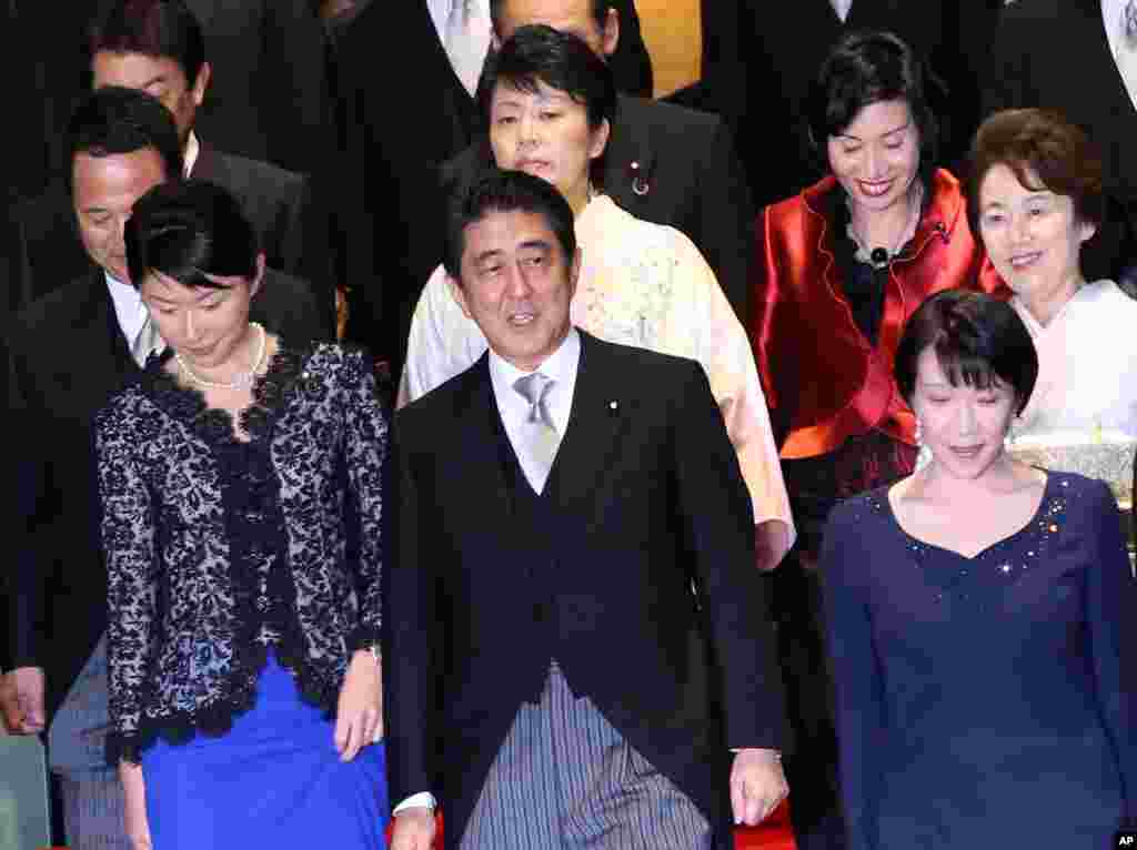 Japan&#39;s Prime Minister Shinzo Abe (front row center) and his new cabinet members gather for a photo session following the first cabinet meeting at the prime minister&#39;s official residence in Tokyo, Sept. 3, 2014.